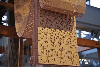 Image of a chain of punch cards used by a Jacquard loom machine